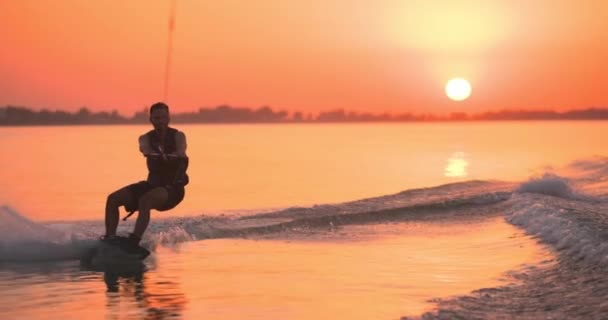 Wakesurfer Rider Ombord Sjö Närbild Teal Wakeboard Filmad Vid Solnedgången — Stockvideo