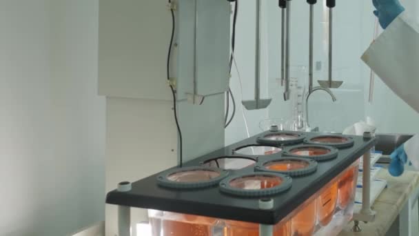 Technik Laboratoryjny Odzieży Ochronnej Pobierający Próbki Chemiczne Automatycznego Mieszalnika Laboratorium — Wideo stockowe