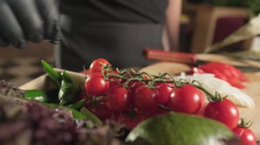 Şef, eldivenli bir sepet ottan domates topluyor. Yavaş Hareket, Kapat.