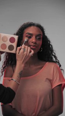 Dubai, BAE - 710 2023: Profesyonel bir makyöz genç bir mankenin yüzüne makyaj uygular. Yavaş Hareket, Kapat.