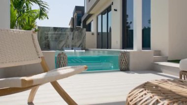 Güneşli bir günde Dubai 'de lüks bir villanın arka bahçesinde küçük özel bir yüzme havuzu. Dışarıda, Yavaş Hareket.