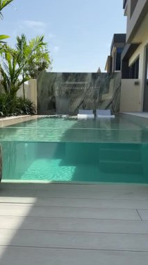 Güneşli bir günde Dubai 'de lüks bir villanın arka bahçesinde küçük özel bir yüzme havuzu. Dışarıda, Yavaş Hareket.