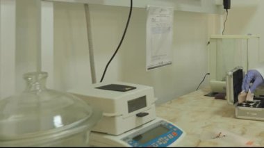 İnsanlar kimya laboratuvarında çalışıyor. Koruyucu giysiler, ekipmanlar, parlak ışıklar. Yavaş Hareket.