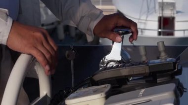 Kaptanların elleri dümende kalsın. Yatın hareketini kontrol ediyor. Güneşli yaz günü