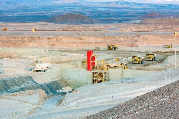 Huge large dump trucks at an open-pit copper mine in Chile.