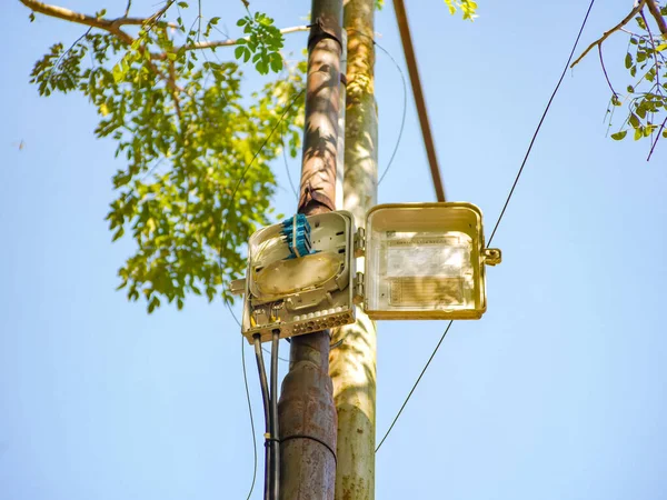 internet or telephone network cable management box that is placed on a high iron pole