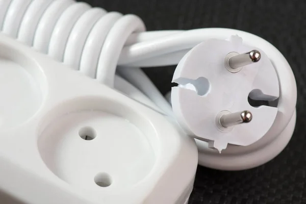 Extension cord close-up. Electrical sockets and household appliances.