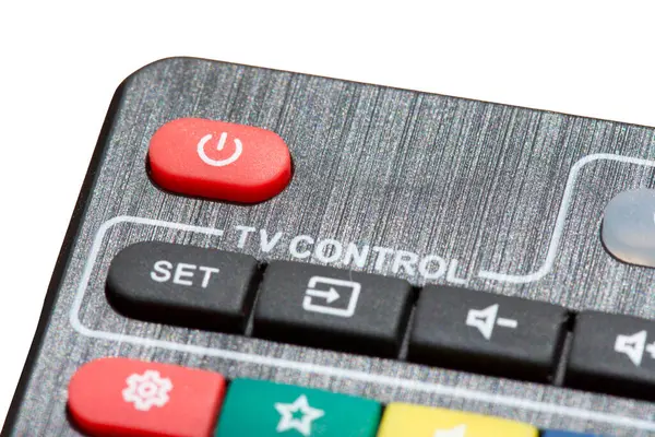 Black tv remote control close up. Red power button on the remote control. hanging and setting channels. Isolated on whte background.