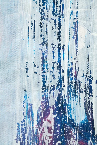 Stained white paint on a blue background. Layering of paint. Smears of white and blue paint.Smears of white and blue paint.