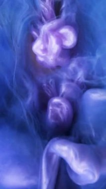 Yavaş hareket eden sıvı renkli mürekkep. Boya suya dökülüyor. Siyah arka planda mürekkep bulutu. Suya soyut mürekkep damlaları..