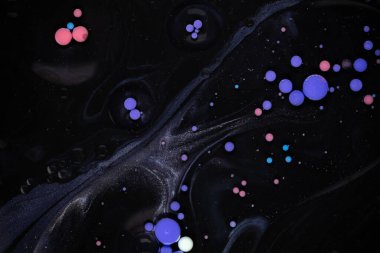 A myriad of oil droplets intermingling with water, creating a mesmerizing effect reminiscent of a galaxy. clipart