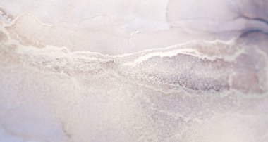 Hassas dokuya sahip beyaz ve gri bir mürekkep girdabının yakın plan fotoğrafı..