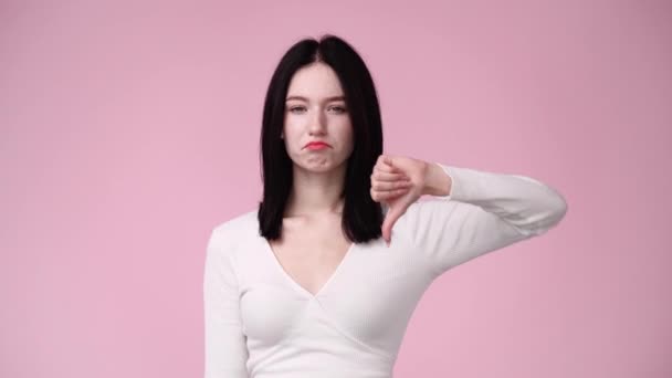 Відео Молодої Жінки Показує Великий Палець Вниз Жестом Над Рожевим — стокове відео