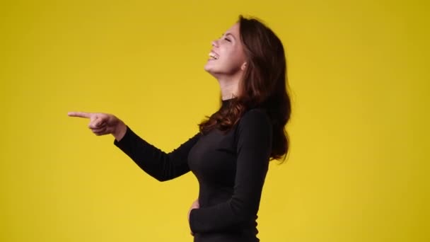 Video One Girl Pointing Left Smiling Yellow Background Concept Emotions — Video