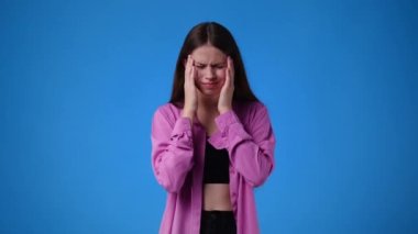 4k slow motion video of one girl feeling bad over blue background. Concept of emotions.