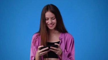 4k video of one girl sending messages on blue background. Concept of emotions.