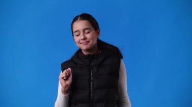 4k slow motion video of one girl dancing over blue background. Concept of emotions.