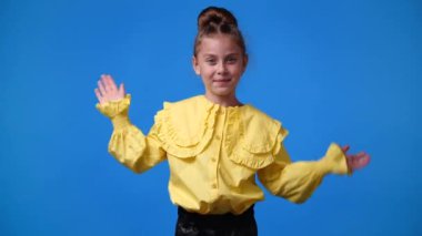 4k video of one girl waving hello on blue background. Concept of emotions.