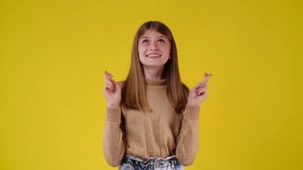 4K慢动作视频一个女孩希望在黄色背景上的东西 情绪的概念 — 图库视频影像