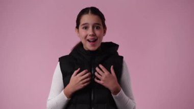 4k slow motion video of one girl feeling emotional over pink background. Concept of emotions.