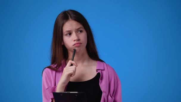 Slow Motion Video Girl Thoughtful Facial Expression Blue Background Concept — Stockvideo