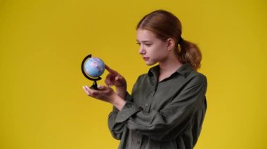 4k video of one girl looking at small globe. Concept of emotions.