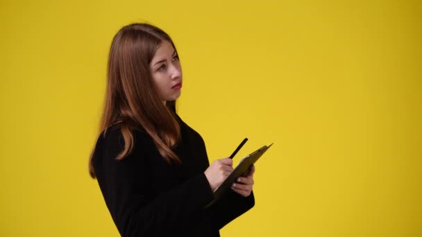 Slow Motion Video One Girl Taking Notes Yellow Background Concept — Vídeo de stock