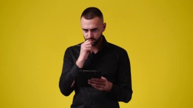 4k video of one man taking notes over yellow background. Concept of emotions.