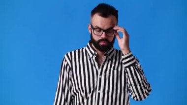 4k slow motion video of one man posing for a video over blue background. Concept of emotions.