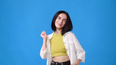 4k slow motion video of one girl dancing over blue background. Concept of emotions.