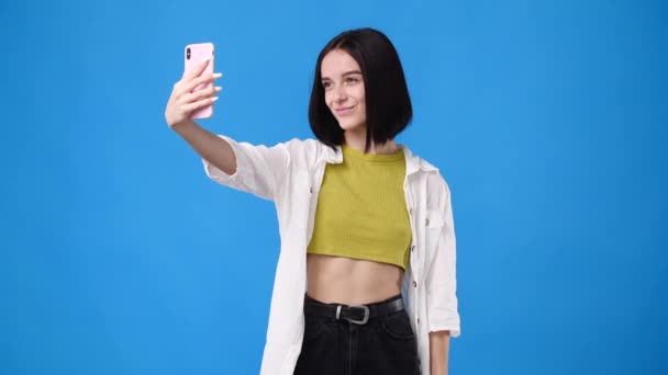 Slow Motion Video Beautiful Girl Making Selfie Blue Background Concept — Stockvideo