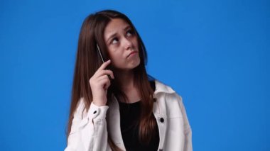 4k slow motion video of one girl thinking about something with a pen in hand. Concept of emotions.