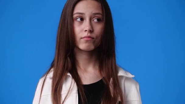 Slow Motion Video One Girl Looking Side Side Blue Background — Stockvideo