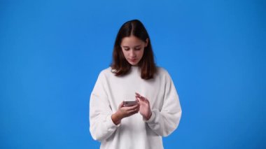 4k slow motion video of one girl streaming over blue background. Concept of blogger.