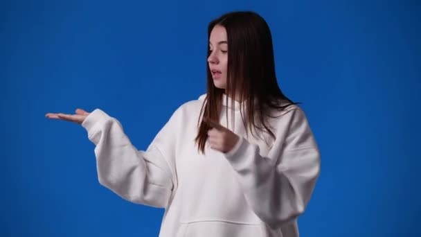 Video One Girl Pointing Left Showing Thumbs Blue Background Concept — Vídeo de Stock