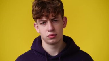 4k video of one man posing for a video over yellow background. Concept of emotions.