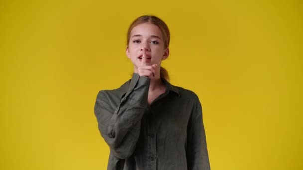 Slow Motion Video Girl Showing Silent Sign Yellow Background Concept — Wideo stockowe