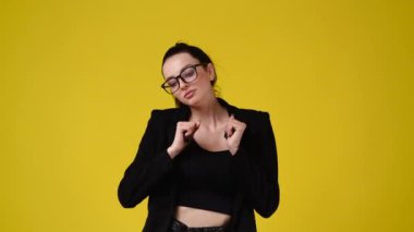 4k video of one girl dancing on yellow background. Concept of emotions.