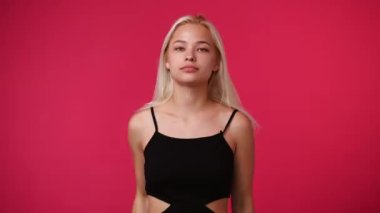 4k video of one girl stops and prohibits over pink background. Concept of emotions.