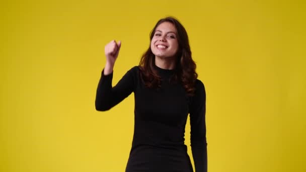 Slow Motion Video One Woman Rejoicing Wave Hand Yellow Background — Video