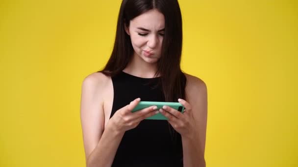 Video One Girl Playing Phone Yellow Background Concept Emotions — Stock Video