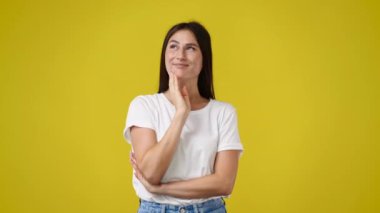 4k video of one girl thinking about something on yellow background. Concept of emotions.