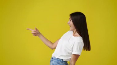 4k video of side view of one girl pointing at left and laughing. Concept of emotions.