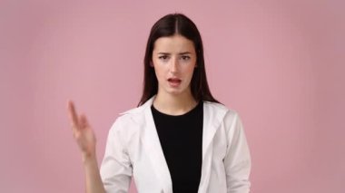 4k slow motion video of one girl gesturing stop over pink background. Concept of emotions.