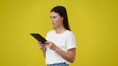 4k video of one girl with negative facial expression and note pad. Concept of emotions.