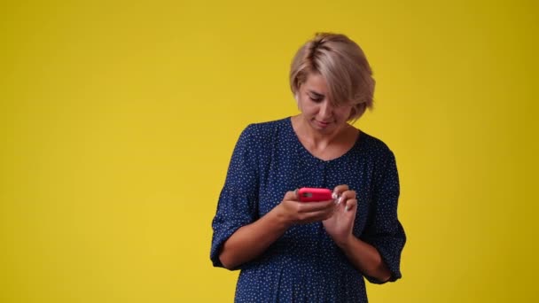 Video One Woman Typing Text Phone Looking Yellow Background Concept — Vídeos de Stock