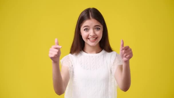 Video Fată Arătând Spre Cineva Arătând Degetele Sus Fundal Galben — Videoclip de stoc