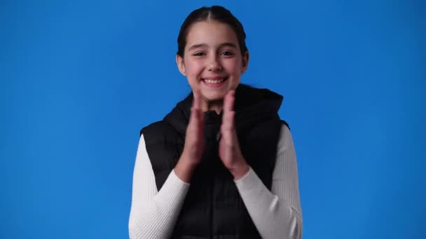 Video One Young Girl Claps His Hands Smiling Blue Background — Stockvideo