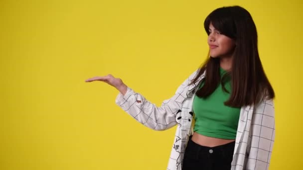 Video One Girl Showing Left Yellow Background Concept Emotions — Vídeos de Stock
