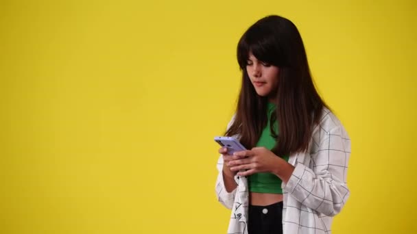 Video One Girl Sending Message Points Left Yellow Background Concept — Vídeo de Stock